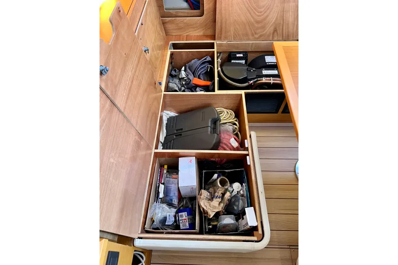 Slide: The Image of Storage compartments on a 2018 Jeanneau 54 yacht, organized with various boating equipment. - 51