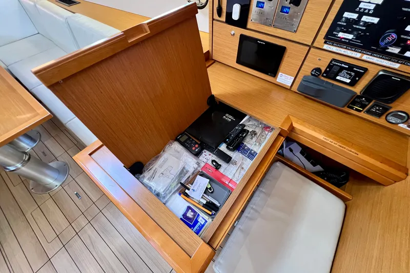Slide: The Image of Interior of 2018 Jeanneau 54 yacht showing navigation station and storage compartment. - 59