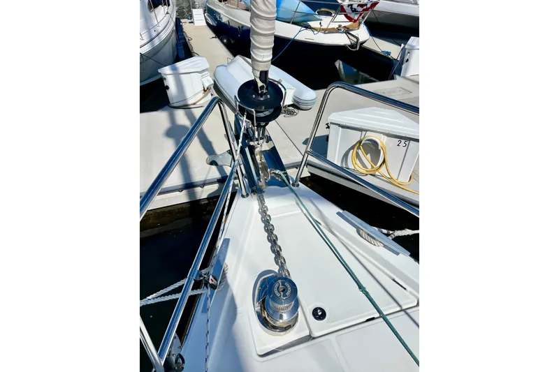 Slide: The Image of Bow of 2018 Jeanneau 54 yacht with anchor chain and docked surroundings. - 17