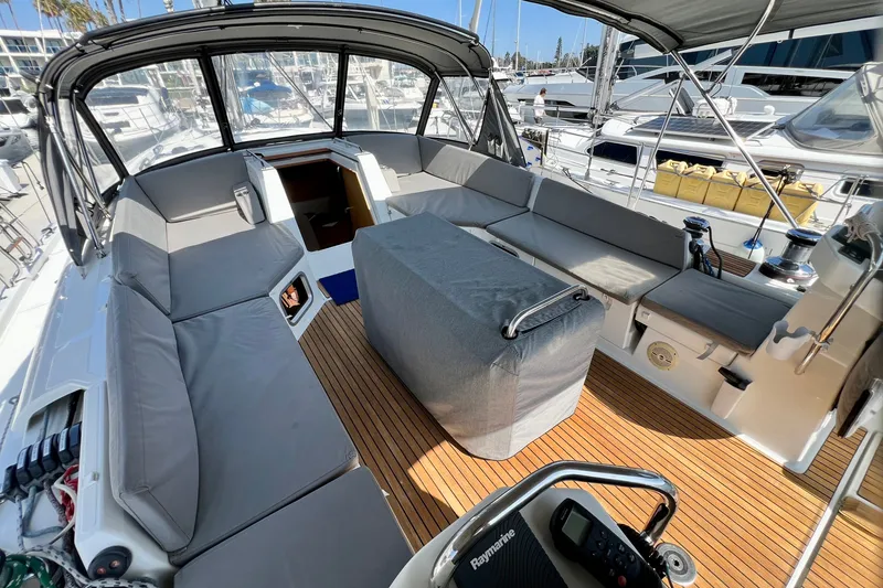 Slide: The Image of Spacious cockpit of a 2018 Jeanneau 54 yacht with cushioned seating and teak flooring. - 27