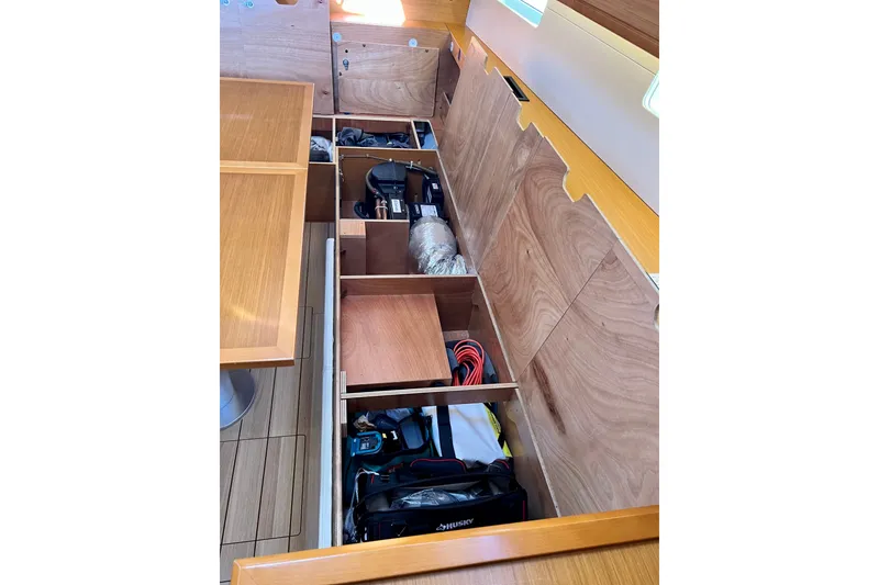 Slide: The Image of Under-seat storage compartments in a 2018 Jeanneau 54 yacht, showcasing organized equipment. - 52