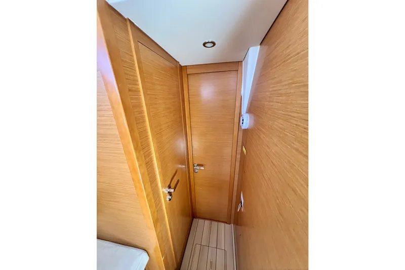 Slide: The Image of Interior hallway of 2018 Jeanneau 54 yacht with wooden doors and flooring. - 82