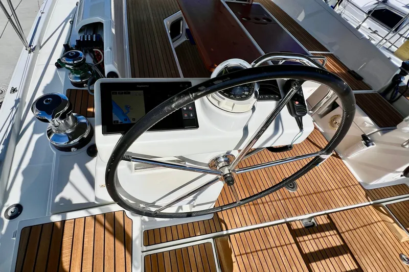 Slide: The Image of Steering wheel and navigation controls on a 2018 Jeanneau 54 yacht deck. - 34