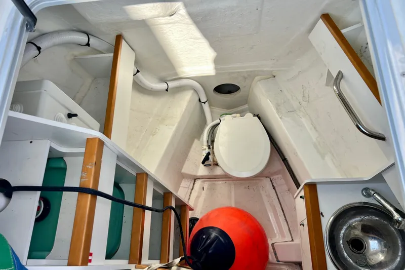 Slide: The Image of Interior of 2018 Jeanneau 54 sailboat bathroom with toilet, sink, and storage. - 39
