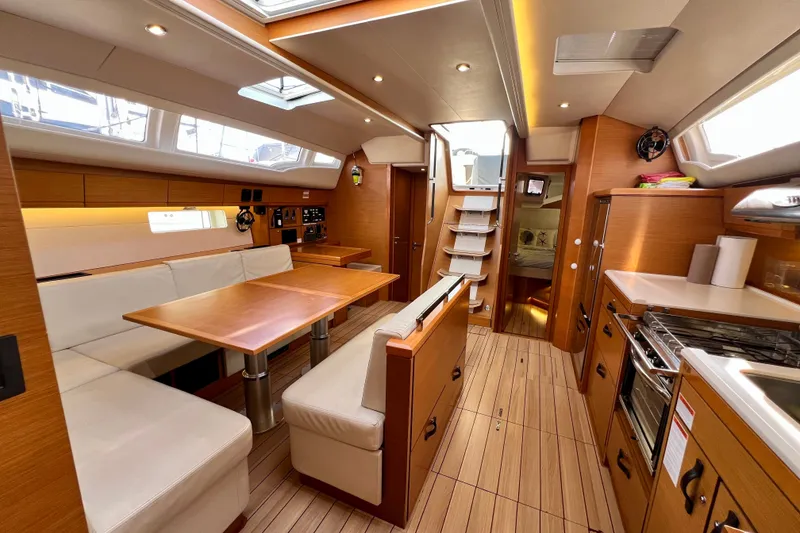 Slide: The Image of Luxurious interior of a 2018 Jeanneau 54 yacht with modern kitchen and dining area. - 81
