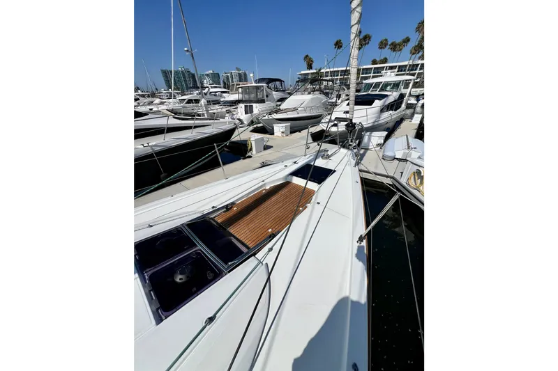 Slide: The Image of 2018 Jeanneau 54 yacht docked in a marina with other boats. - 19