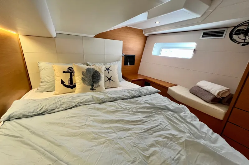 Slide: The Image of Luxurious cabin interior of 2018 Jeanneau 54 yacht with nautical-themed pillows. - 93