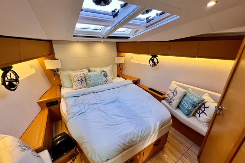 Slide: The Image of Luxurious cabin interior of 2018 Jeanneau 54 yacht with cozy bedding and nautical decor. - 72