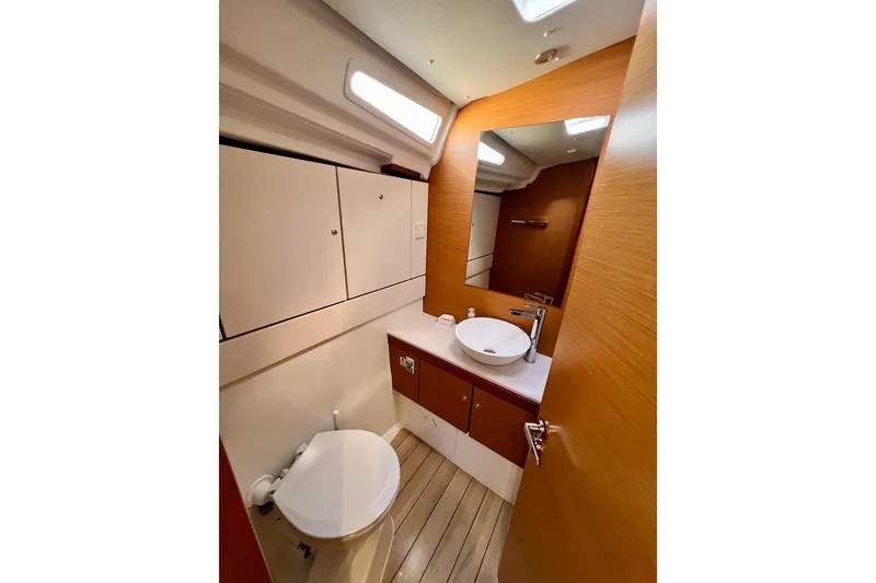 Slide: The Image of Modern bathroom interior of 2018 Jeanneau 54 yacht with wood accents and sleek fixtures. - 79