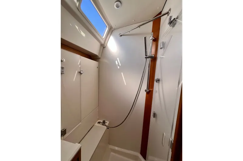 Slide: The Image of Modern shower area in 2018 Jeanneau 54 yacht, featuring sleek fixtures and natural lighting. - 97