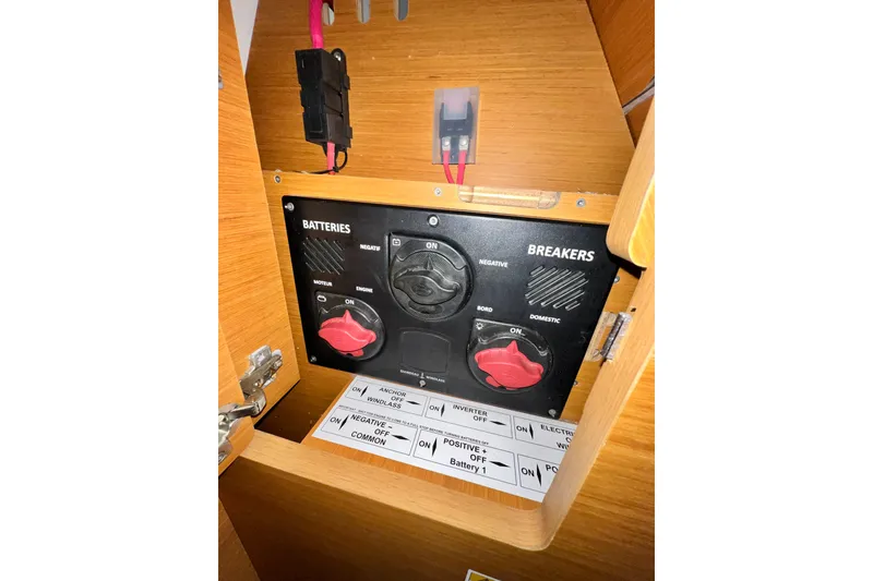 Slide: The Image of Electrical panel of a 2018 Jeanneau 54 yacht, featuring battery and breaker controls. - 68