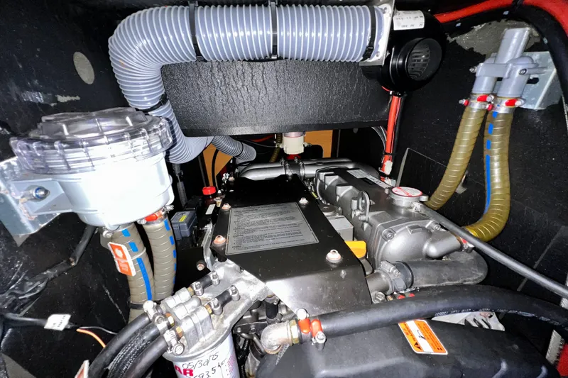 Slide: The Image of Engine compartment of a 2018 Jeanneau 54 yacht, showcasing mechanical components and hoses. - 69
