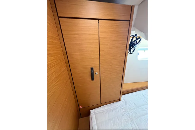 Slide: The Image of 2018 Jeanneau 54 yacht interior with wooden wardrobe and bed. - 85