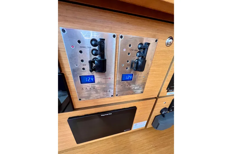Slide: The Image of Electrical control panel on a 2018 Jeanneau 54 yacht, displaying voltage readings. - 62