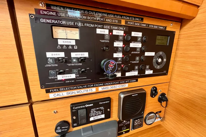 Slide: The Image of Control panel of a 2018 Jeanneau 54 yacht with various switches and indicators. - 64