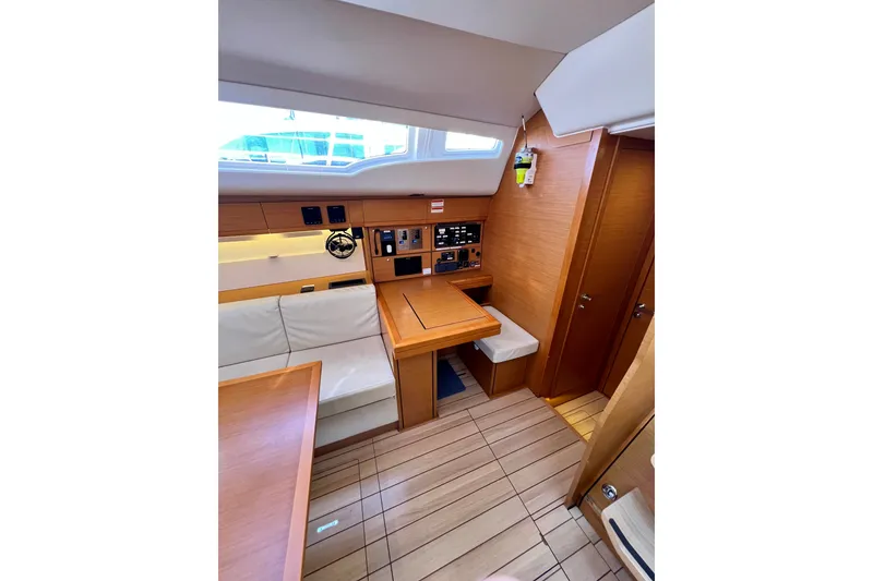 Slide: The Image of Interior of 2018 Jeanneau 54 yacht with wooden finish and seating area. - 56