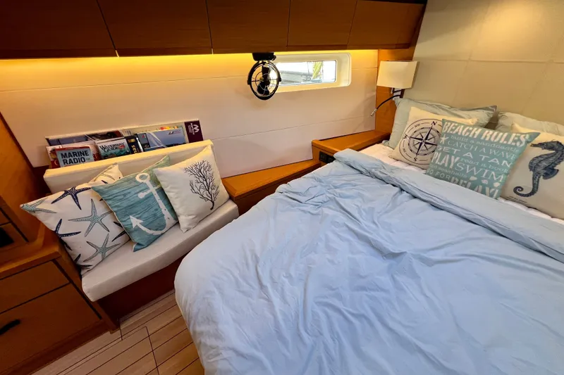 Slide: The Image of Cozy cabin interior of 2018 Jeanneau 54 yacht with nautical-themed decor and bedding. - 75