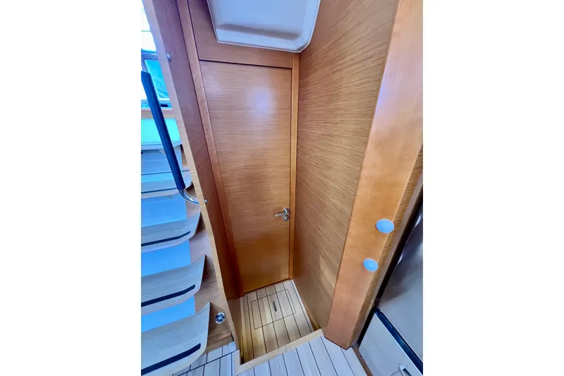 Slide: The Image of Interior of 2018 Jeanneau 54 yacht, featuring wooden door and staircase. - 90