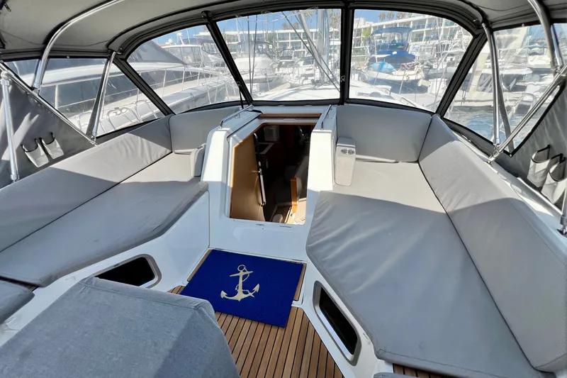 Slide: The Image of Spacious cockpit of 2018 Jeanneau 54 yacht with cushioned seating and nautical decor. - 28