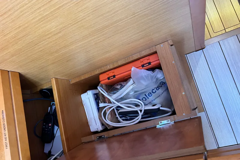 Slide: The Image of Storage compartment on 2018 Jeanneau 54 yacht with cables and emergency kit. - 60