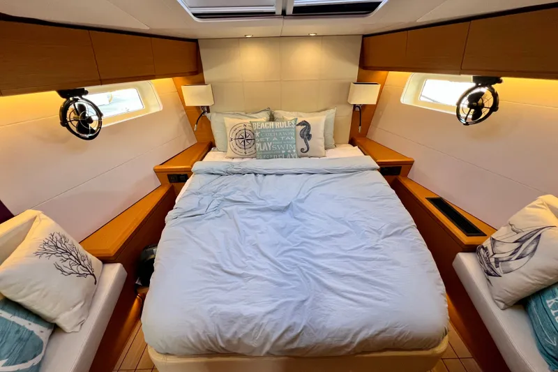 Slide: The Image of Luxurious cabin interior of 2018 Jeanneau 54 yacht with cozy bedding and nautical decor. - 74