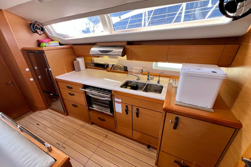 Slide: The Image of Modern kitchen interior of 2018 Jeanneau 54 yacht with wooden cabinetry and appliances. - 44