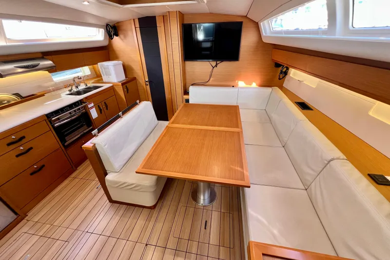 Slide: The Image of Luxurious interior of 2018 Jeanneau 54 yacht with modern kitchen and cozy seating area. - 53