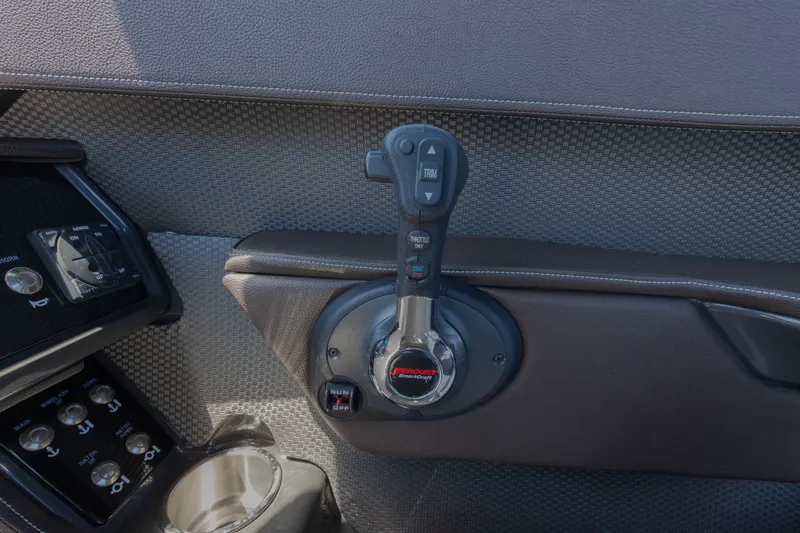 Slide: The Image of Close-up of the throttle lever on a 2016 Sea Ray SLX 250, surrounded by upholstered material. - 11