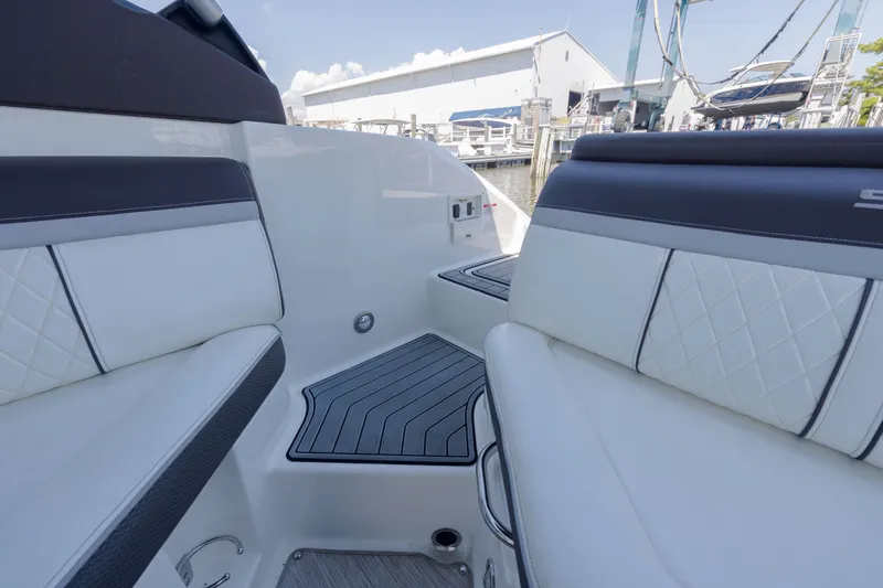 Slide: The Image of Interior view of a 2016 Sea Ray SLX 250 with white upholstered seats and gray accents. - 7