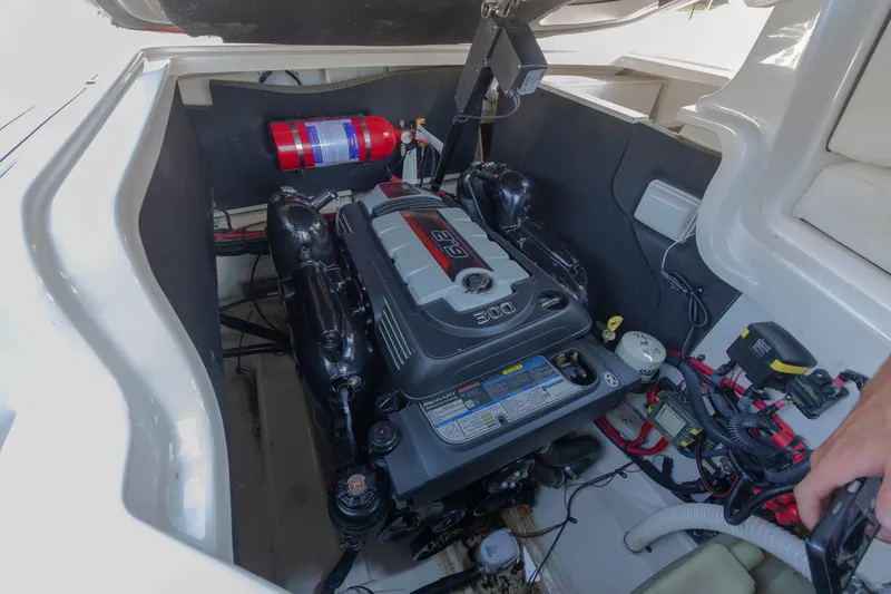Slide: The Image of The engine compartment of a 2016 Sea Ray SLX 250 shows a neatly installed engine with accessories. - 13
