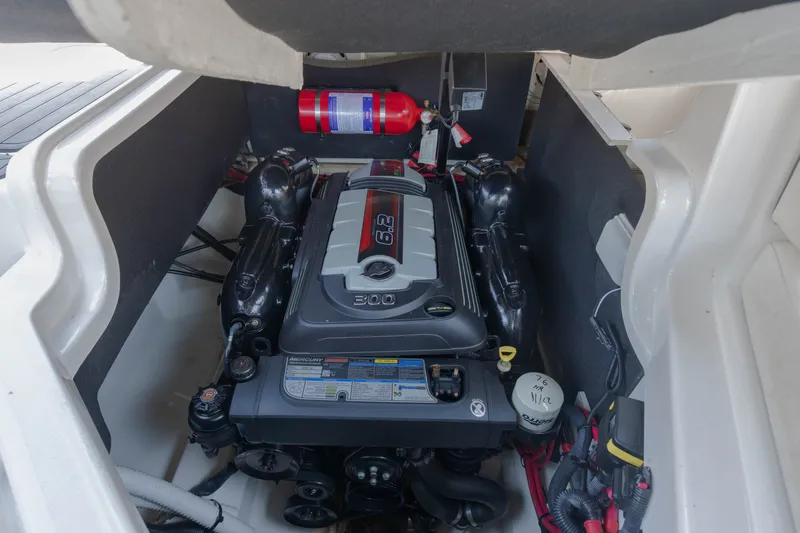 Slide: The Image of The engine compartment of a 2016 Sea Ray SLX 250 features a 6.2-liter engine and a fire extinguisher. - 14