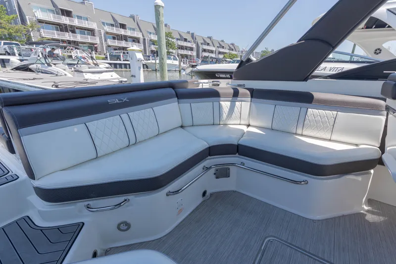 Slide: The Image of The image shows the cockpit of a 2016 Sea Ray SLX 250 boat with sleek white upholstery. - 4