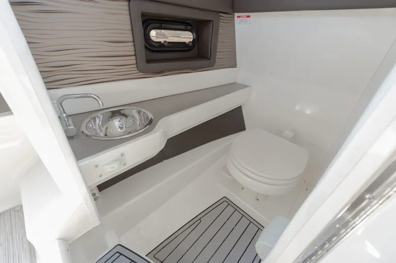 Slide: The Image of The image shows a modern boat bathroom with a sink, toilet, and stylish walls. - 8