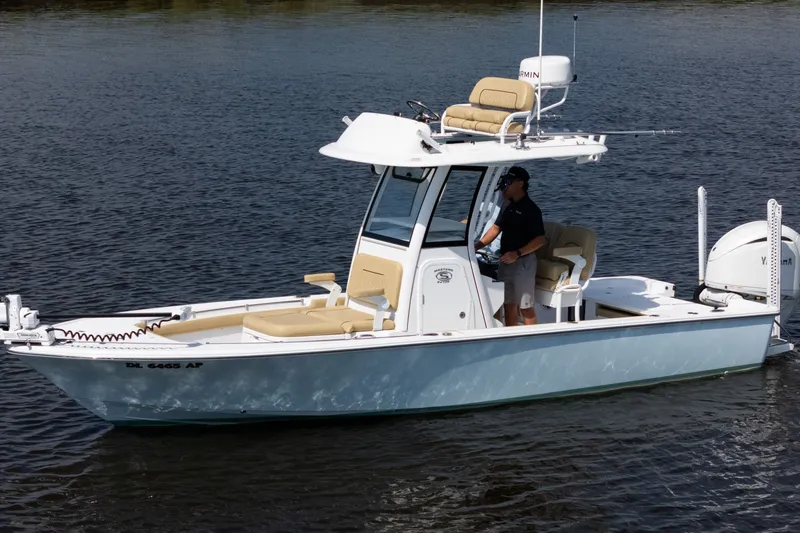 Slide: The Image of 2024 Sportsman Masters 247OE Bay Boat cruising on calm water, featuring modern design and amenities. - 4