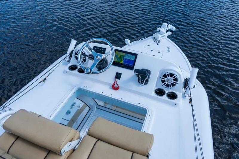Slide: The Image of 2024 Sportsman Masters 247OE Bay Boat dashboard with steering wheel and navigation system. - 11