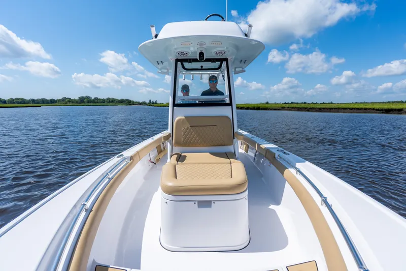 Slide: The Image of 2024 Sportsman Masters 247OE Bay Boat cruising on a sunny day, showcasing sleek design. - 6