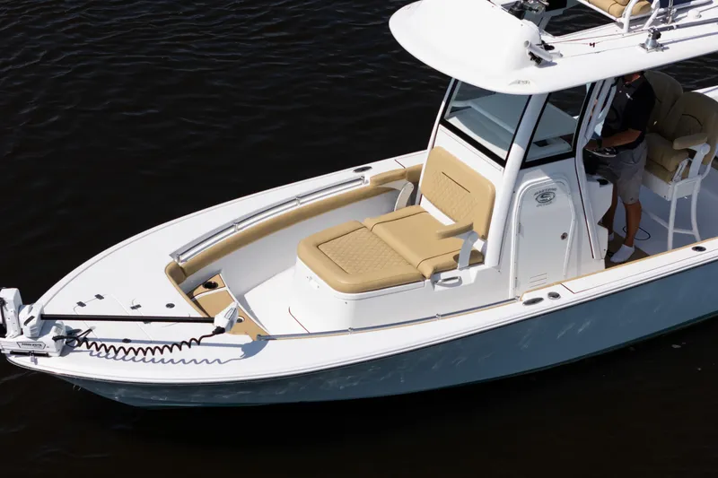 Slide: The Image of 2024 Sportsman Masters 247OE Bay Boat on water, featuring sleek design and comfortable seating. - 5