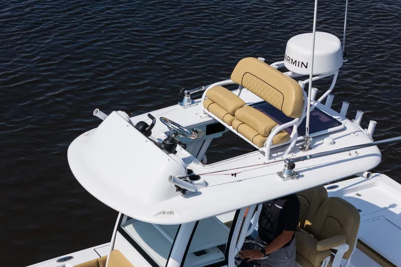 Slide: The Image of 2024 Sportsman Masters 247OE Bay Boat with elevated helm and seating on calm water. - 10