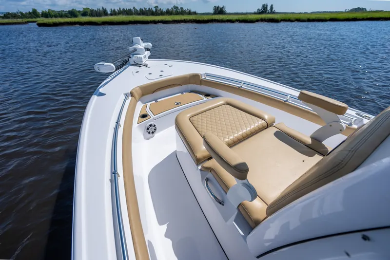 Slide: The Image of 2024 Sportsman Masters 247OE Bay Boat with tan seating on calm water. - 7