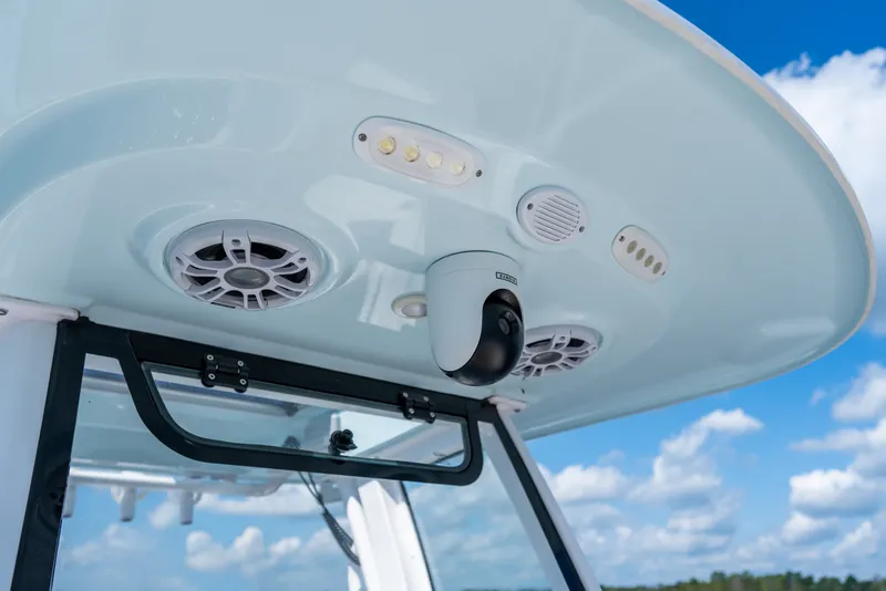 Slide: The Image of 2024 Sportsman Masters 247OE Bay Boat with speakers and camera under canopy. - 15