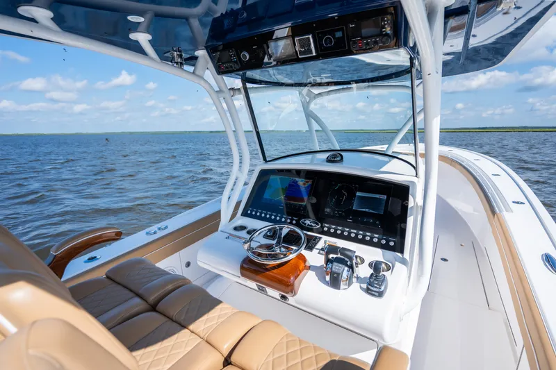 Slide: The Image of 2023 Valhalla Boatworks V-37 helm with advanced navigation systems on open water. - 25