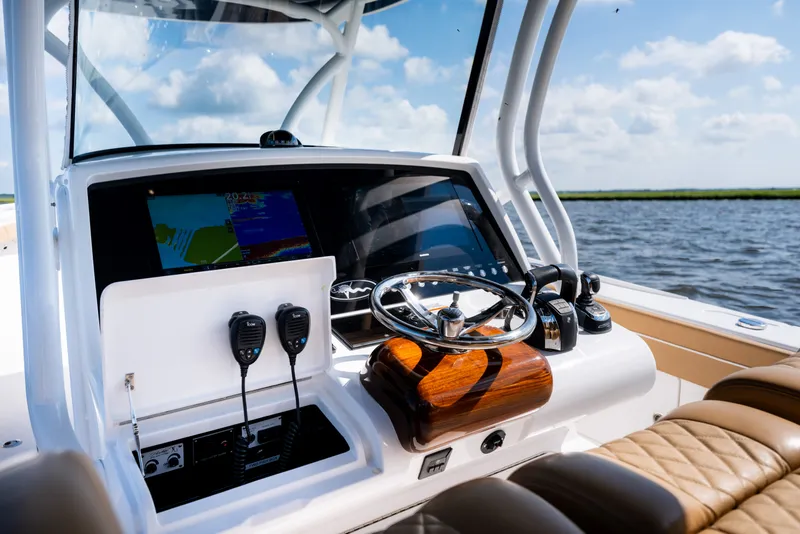 Slide: The Image of 2023 Valhalla Boatworks V-37 helm with advanced navigation systems and luxurious seating. - 23