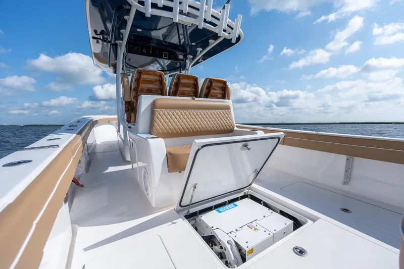 Slide: The Image of 2023 Valhalla Boatworks V-37 with open storage compartment, luxurious seating, and clear skies. - 32