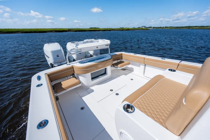 Slide: The Image of 2023 Valhalla Boatworks V-37 on calm water, featuring luxurious seating and dual engines. - 31