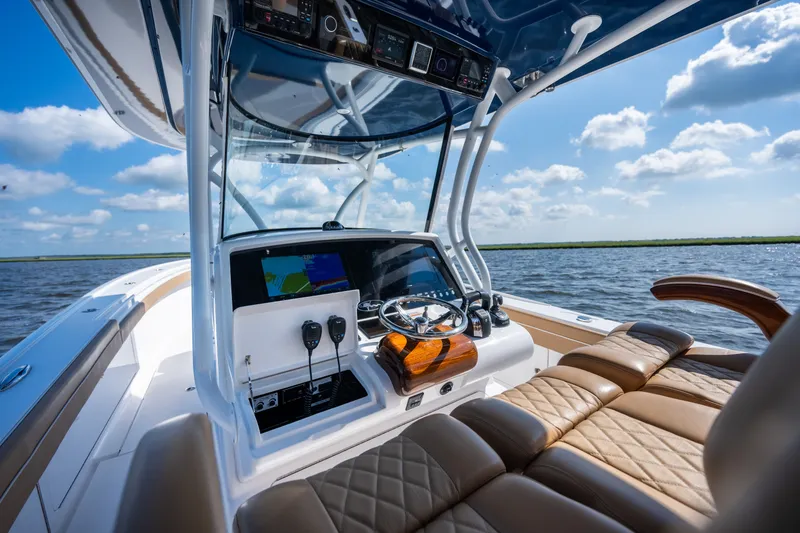 Slide: The Image of 2023 Valhalla Boatworks V-37 helm with luxurious seating and advanced navigation system. - 24