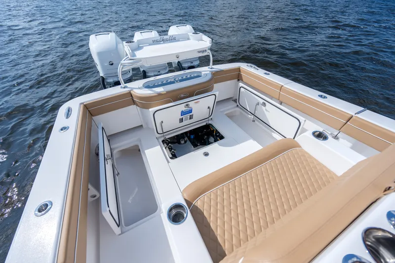 Slide: The Image of 2023 Valhalla Boatworks V-37 interior with tan seating and storage compartments on water. - 30