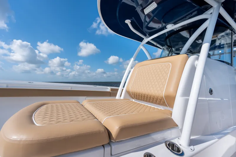 Slide: The Image of 2023 Valhalla Boatworks V-37 with tan seating, blue sky, and ocean backdrop. - 17