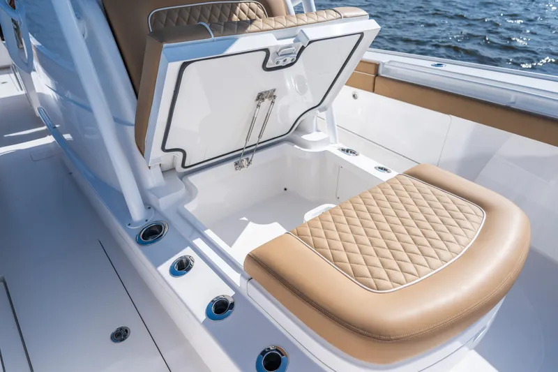 Slide: The Image of 2023 Valhalla Boatworks V-37 seat with storage compartment, featuring tan quilted upholstery. - 19