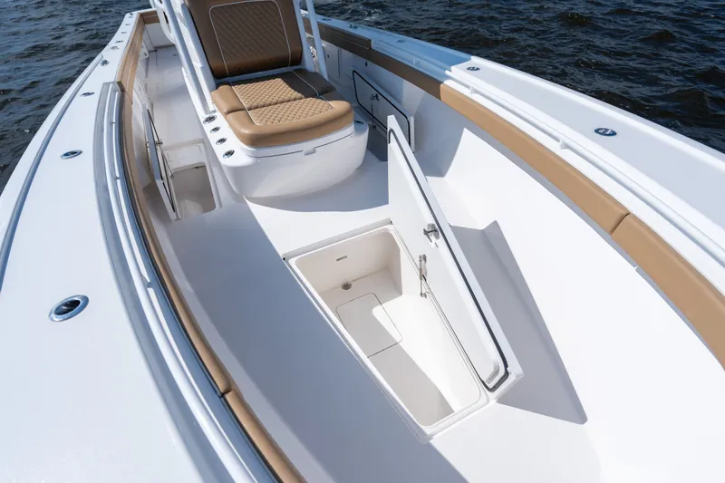 Slide: The Image of 2023 Valhalla Boatworks V-37 interior with open storage compartment and cushioned seating. - 14