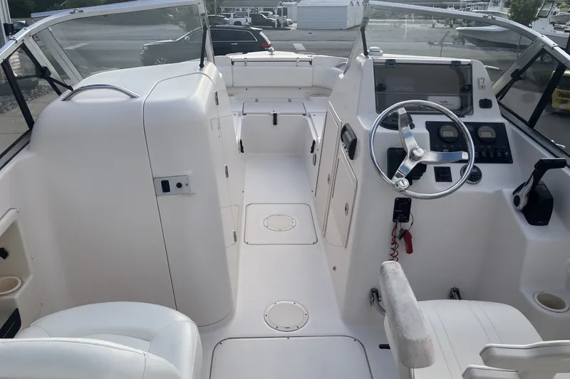 Slide: The Image of 2005 Grady-White Tournament 225 boat interior with steering wheel and seating. - 13